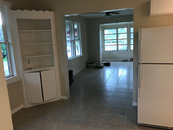 looking from kitchen to family room and entryway beyond