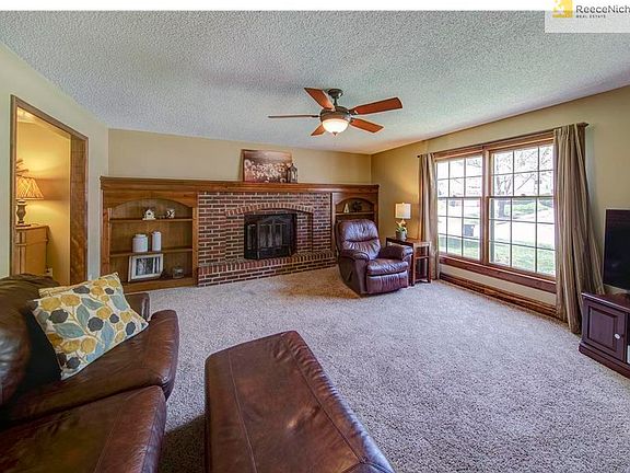 Large Great Room with beautiful brick fireplace and flanking built-ins.