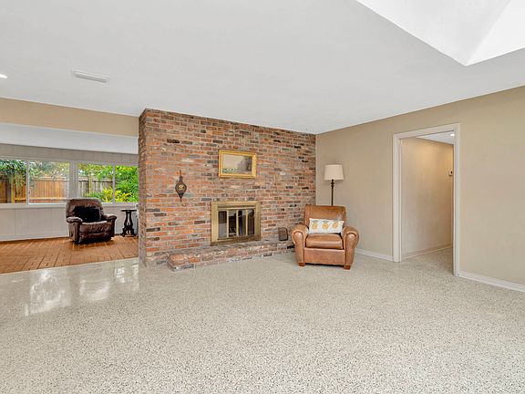 Sitting room with terrazzo floor, fireplace, and skylight