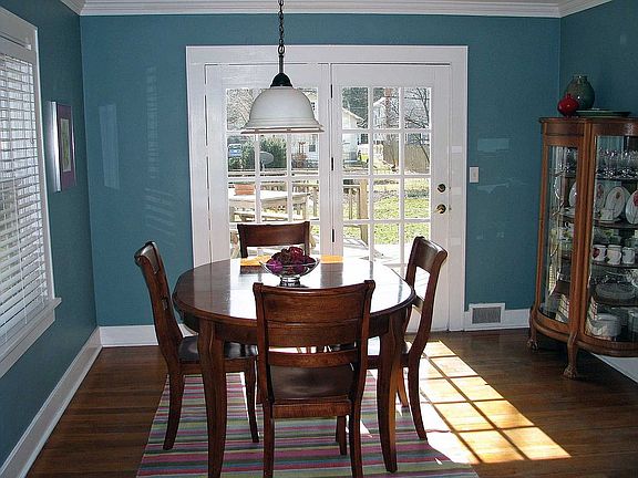 Dining room with hardwood floors and french-style doors to back deck.