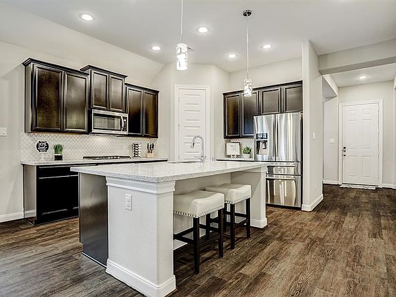 What a kitchen! From the sleek white backsplash to the high end granite countertops, this kitchen is perfect for cooking and ent
