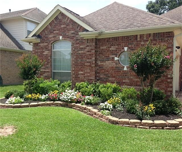 lovely landscaped yard that offers sprinkler system in the front and back for easy watering