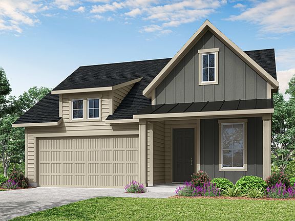 A two-story house with a gabled roof, siding in neutral tones, and a garage door stands in a landsca
