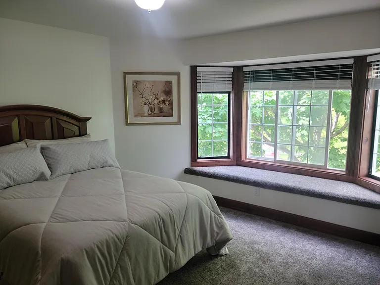 Master bedroom is cozy and private with big maple trees just outside the large windows.