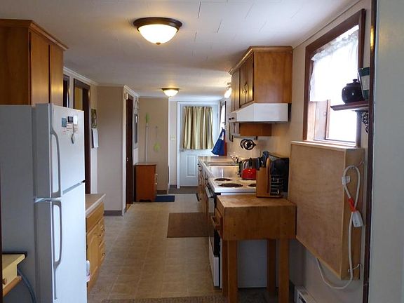 This is a view from the living room through the kitchen to the front door. You can see what a nice, spacious area this is to work in.