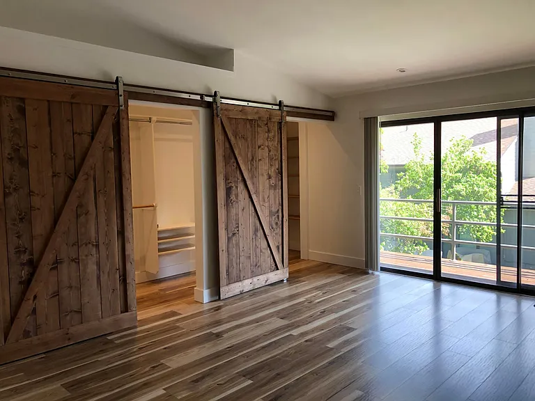 Barn doors glide easily along single track with open shelf area above for decorating or storage.