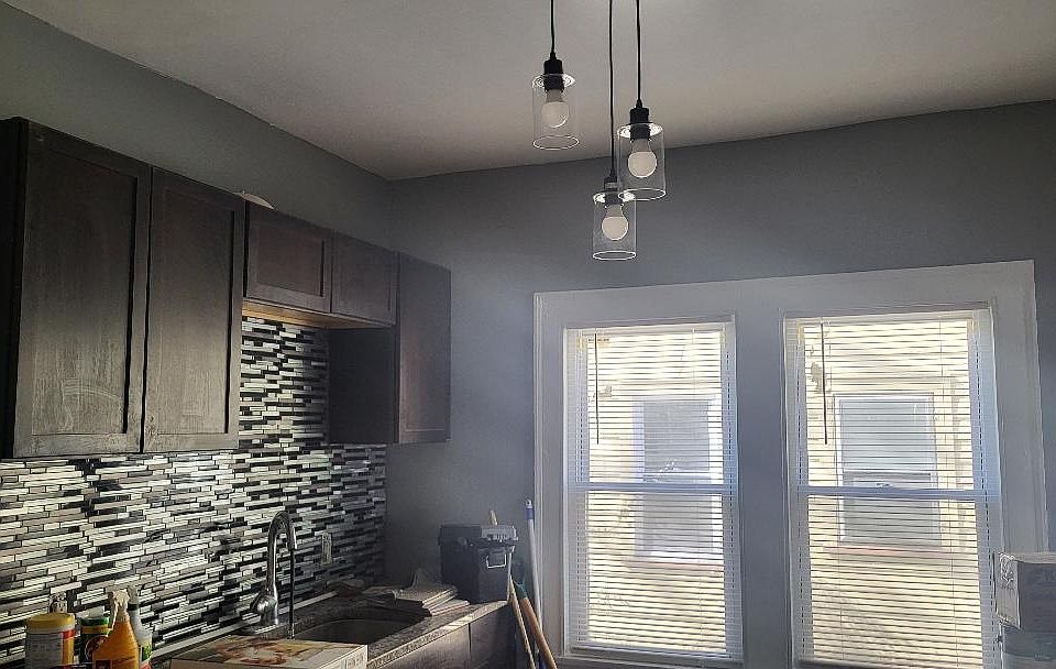 Kitchen with granite countertop, tile flooring, and lots of natural light