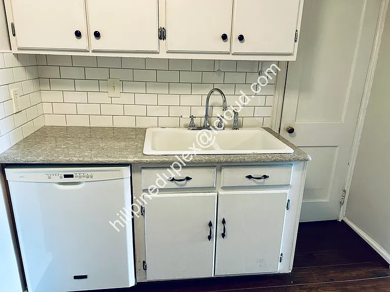 Spacious kitchen quartz counter tops with gas stove, built-in microwave, fridge, dishwasher, garbage disposal, and pantry