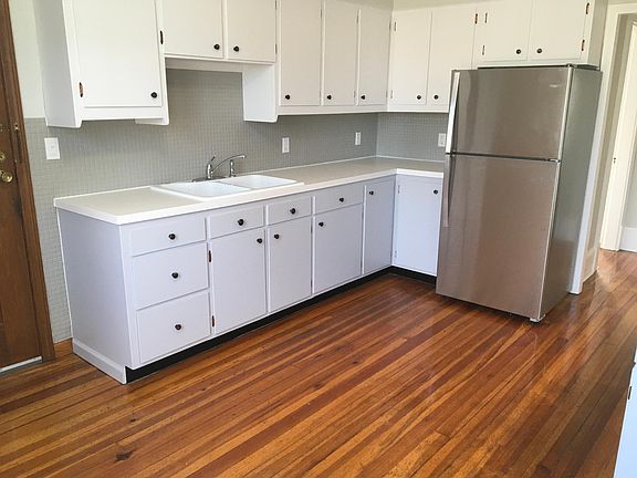 Two-tone cabinets; lots of storage and counter space, more cabinets and counter on opposite side