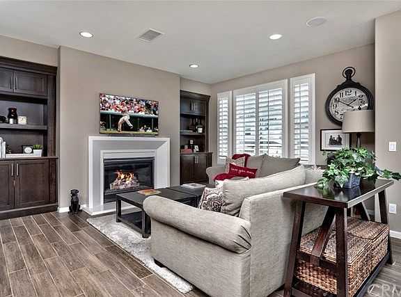 Family Room with F/P Built Ins, Tile Floors, Plantation Shutters.