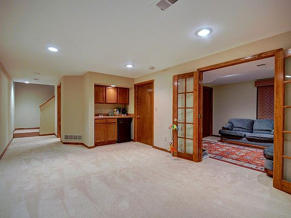 finished basement living space with bed and 3/4 bath