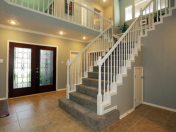 The tiled entry is flanked by the formal dining room and the study.