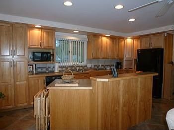Hickory cabinets anchor this open kitchen.  You'll love the beautiful heated ceramic tile floors!