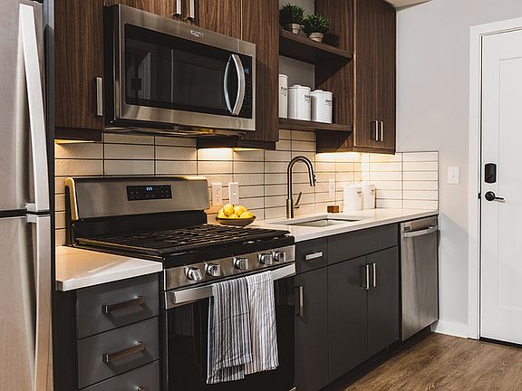 Kitchens with stainless steel appliances and custom cabinetry with chrome pulls