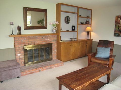 Main Floor Family Room Complete with Wood-Burning Fireplace and Built-in Bookcas