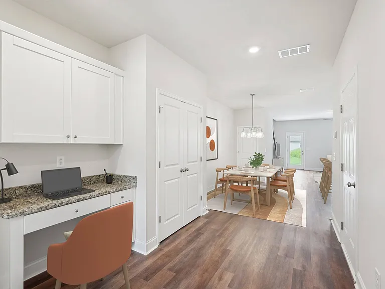 The entrance to the Monterey home featuring rich hardwood-style flooring and crisp white walls.