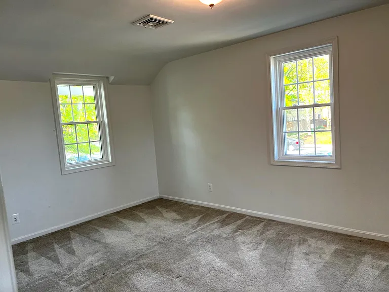 Bedroom 1 has lots of light with 3 windows and 2 closets