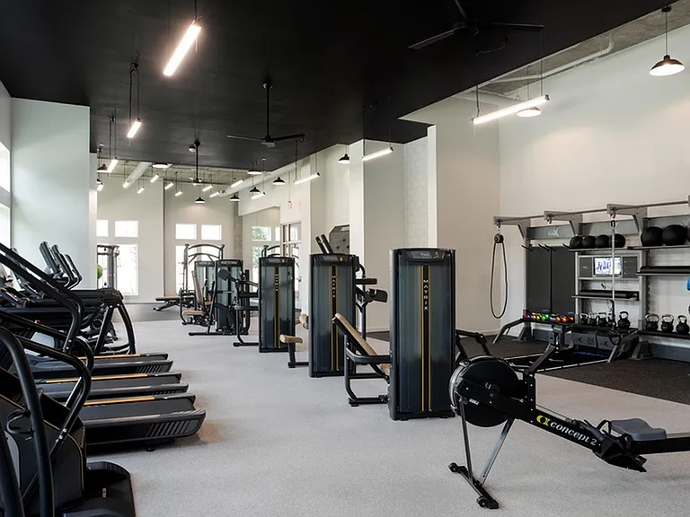 Club-Quality Fitness Studio with Climbing Wall, Peloton Bike, Yoga Studio, Rower, TRX, Cardio, Individual TV's + Weights