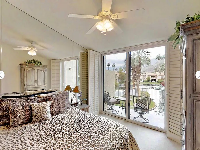 master bedroom, cal king bed,TV in armoire