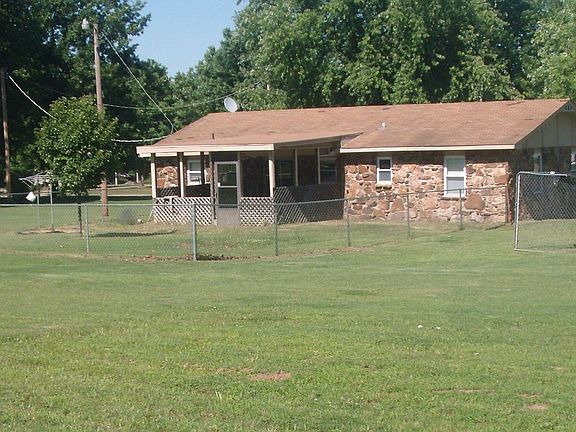 closer shot of back of house w/fenced yard back porch