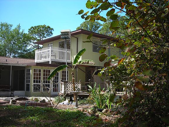 Back of house and park-like yard.