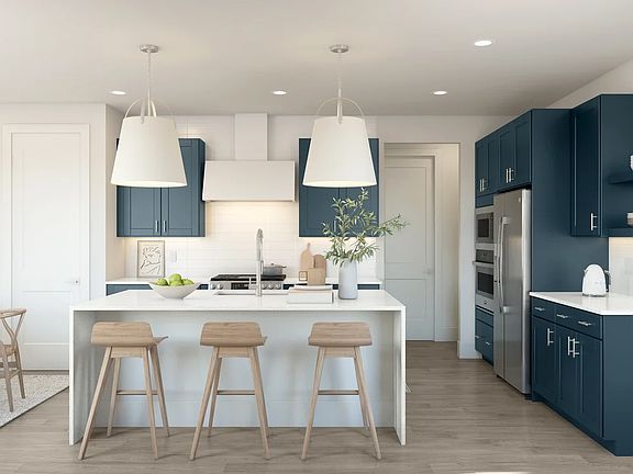 Kitchen with pendant lights waterfall island