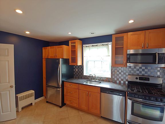 Kitchen with gas stove, door is the entry to basement