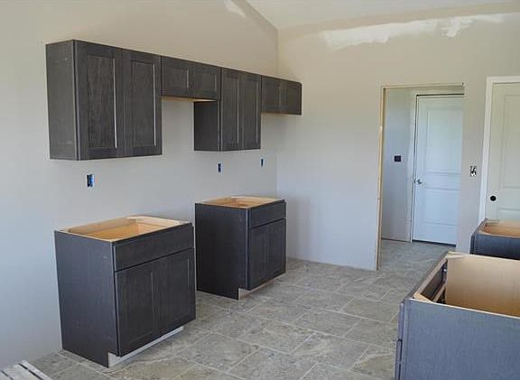 Charcoal color cabinets in kitchen and baths