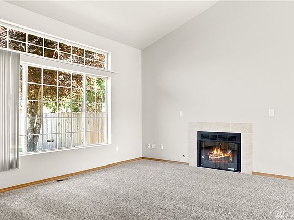 Just off the entry foyer, the living room wows with its size and airy vaulted ceiling. 