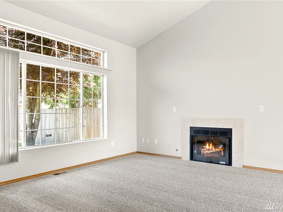 Just off the entry foyer, the living room wows with its size and airy vaulted ceiling. 