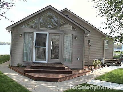 Home Entrance W/ Cement Walkways to Lake