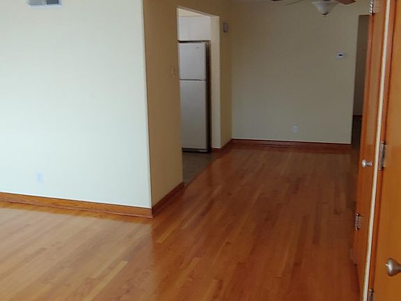 View from Living Room to Dining Room. Note newly finished hardwood floors. Crown Molding.