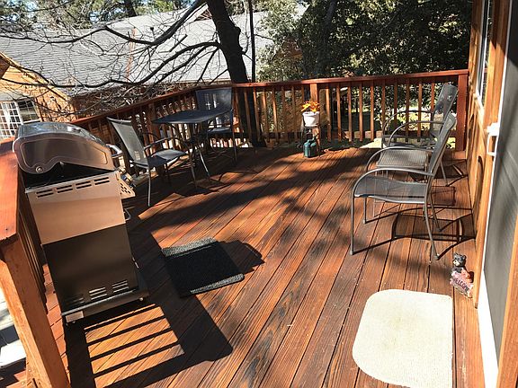Outdoor decking furnished with barbecue.