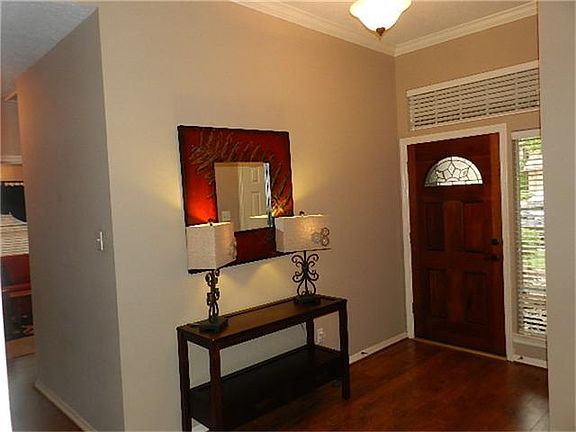 Inviting and spacious entry with crown molding.
