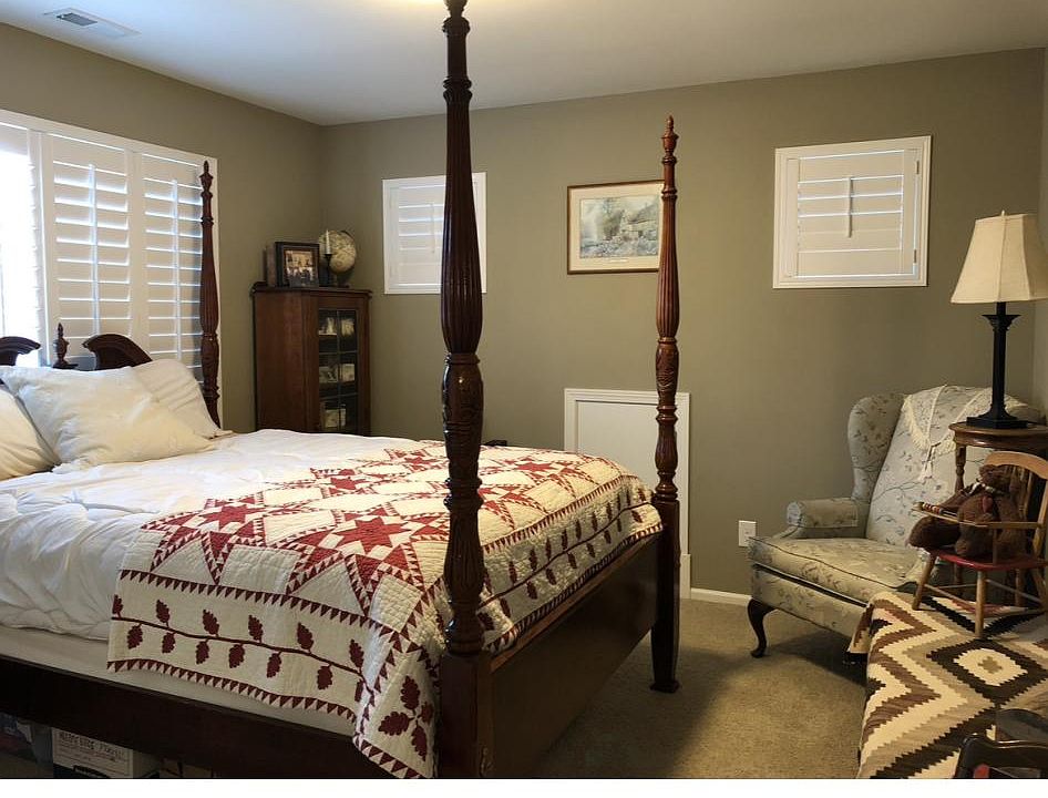 Bedroom with queen size bed and cozy chair