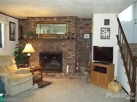 The inviting family room fireplace is gas log which makes it easy to use and enjoy