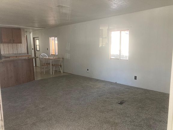 View from the front door. The front room has new carpeting. The kitchen/dining area is on the left of the photo.