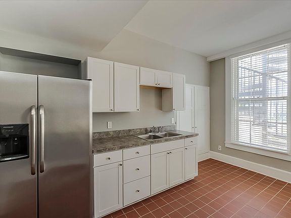 Kitchen with full fridge.