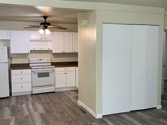 View of the Kitchen and doors where the washer and dryer are.hen from the living area. You can see the doors where the washer and dryer are.