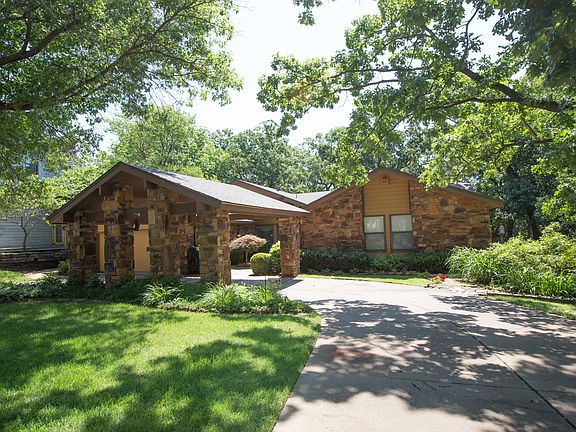 Curb appeal is enhanced by charming and convenient circle drive with Porte Cochere, lush and mature landscape and 2 car Garage with storage.