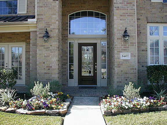 Beautiful entry... notice the gorgeous cut glass door, the porch area with double doors going into the ground floor study.