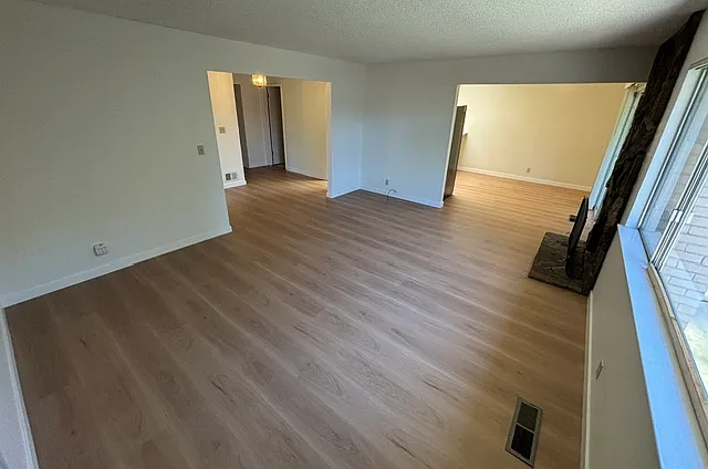 Open living room and dining room with access to backyard