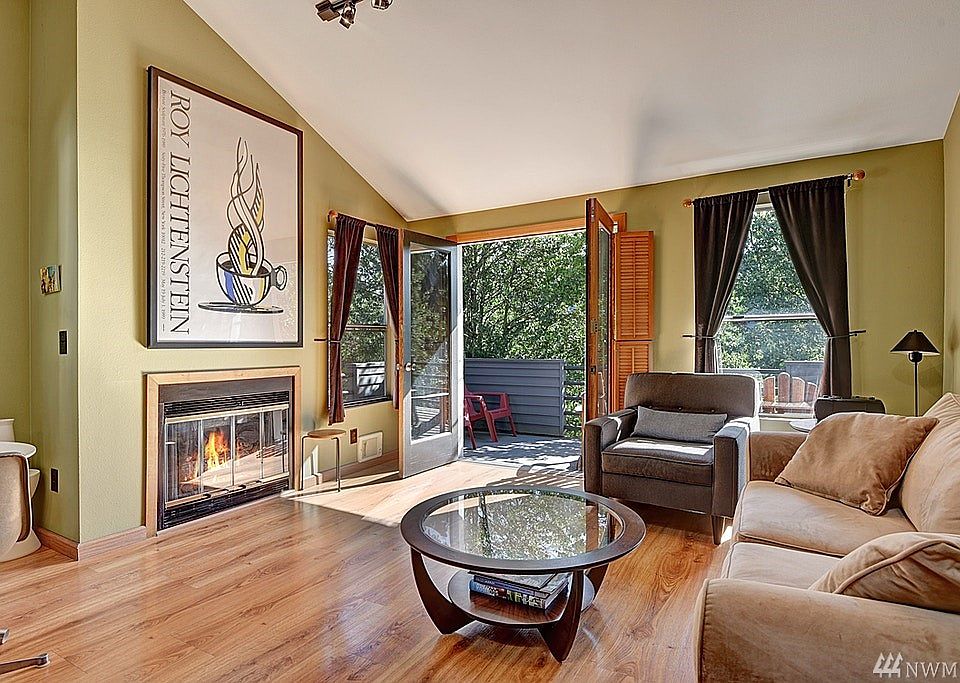 French doors lead to the private deck overlooking quiet tree lined street. You're In-City but the nature and natural light just comes pouring in.