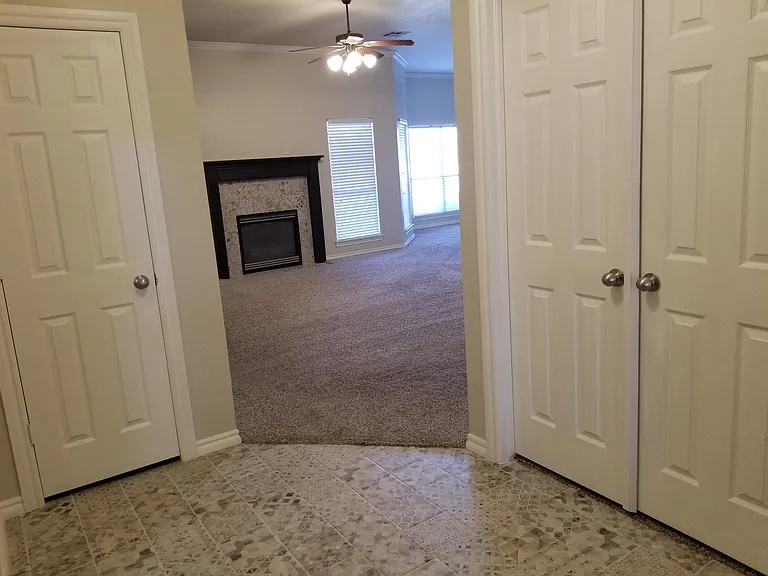 Entry and living room. Office behind double doors. Coat closet behind single door.
