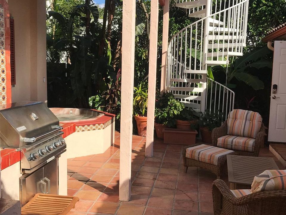 Patio with circ stairs to upper porch