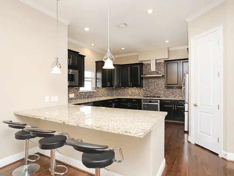 Chefs kitchen with beautiful back splash and modern appliances