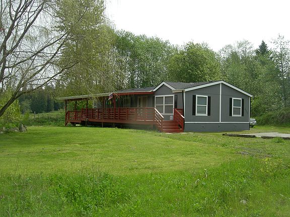 Exterior view of the 3 bedroom 2 bathroom 1400 square foot home including expansive year around cover deck