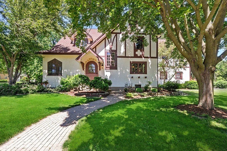 Welcome to this incredibly gorgeous and charming home with a brick sidewalk and mature landscape!