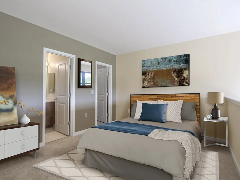 Upgraded bedroom with accent wall and carpet