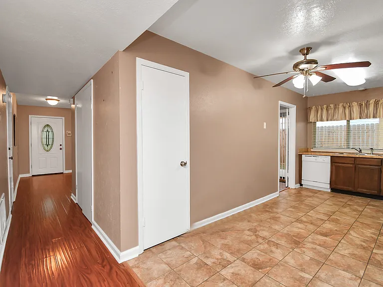 View of entry and two entrances to kitchen and pantry.